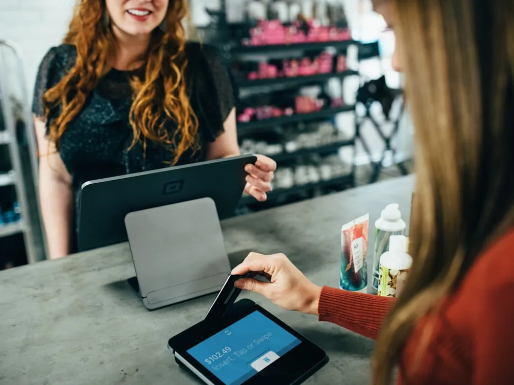 Shop owner calmly handling an order for a customer